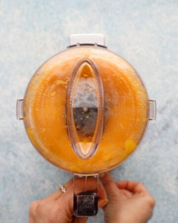 a small food processor with yellow mango puree.
