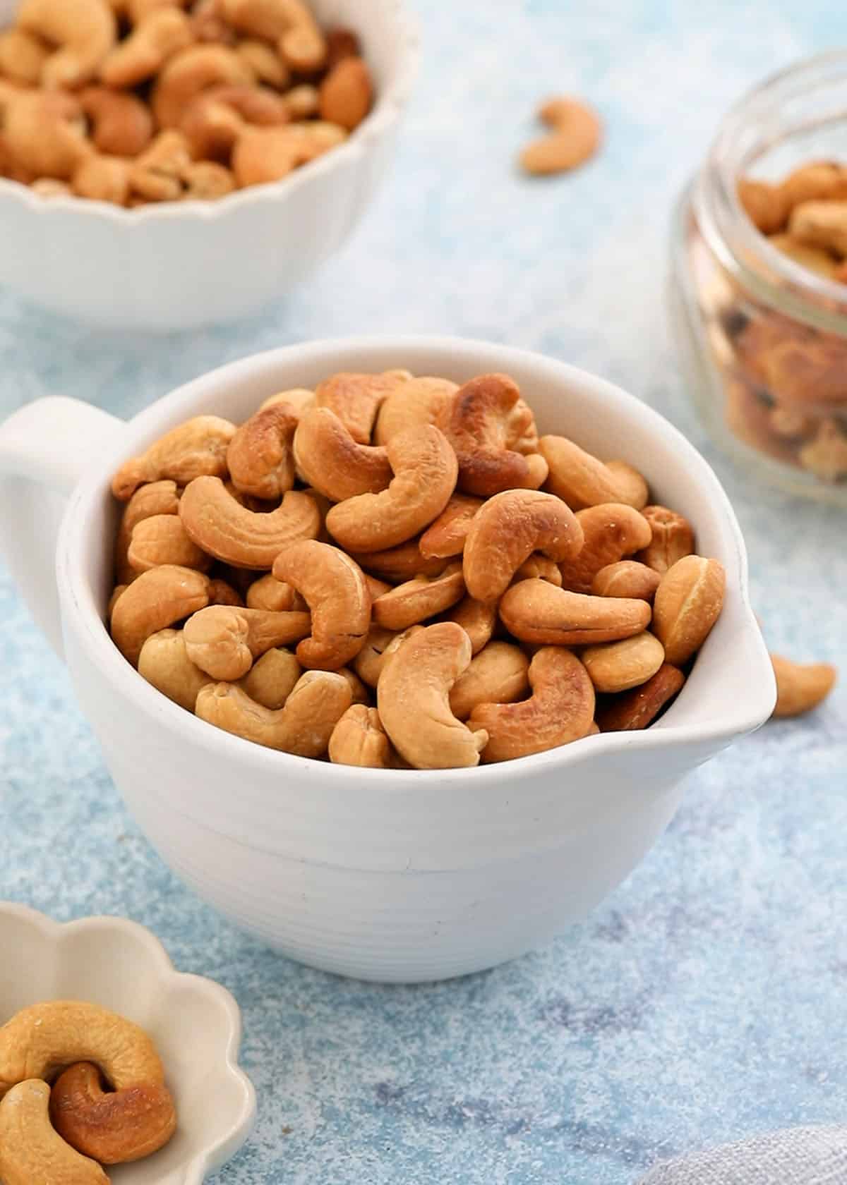 roasted cashew nuts in a white bowl. 