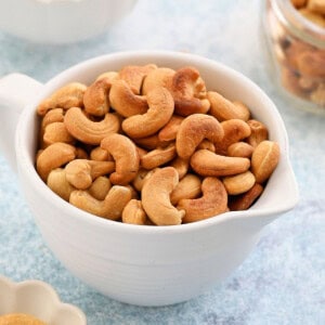 roasted cashew nuts in a white bowl.