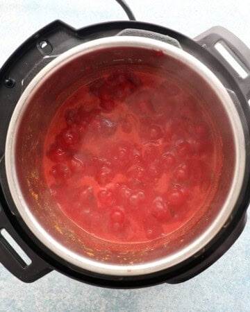 bubbling pink colored curry in an instant pot.