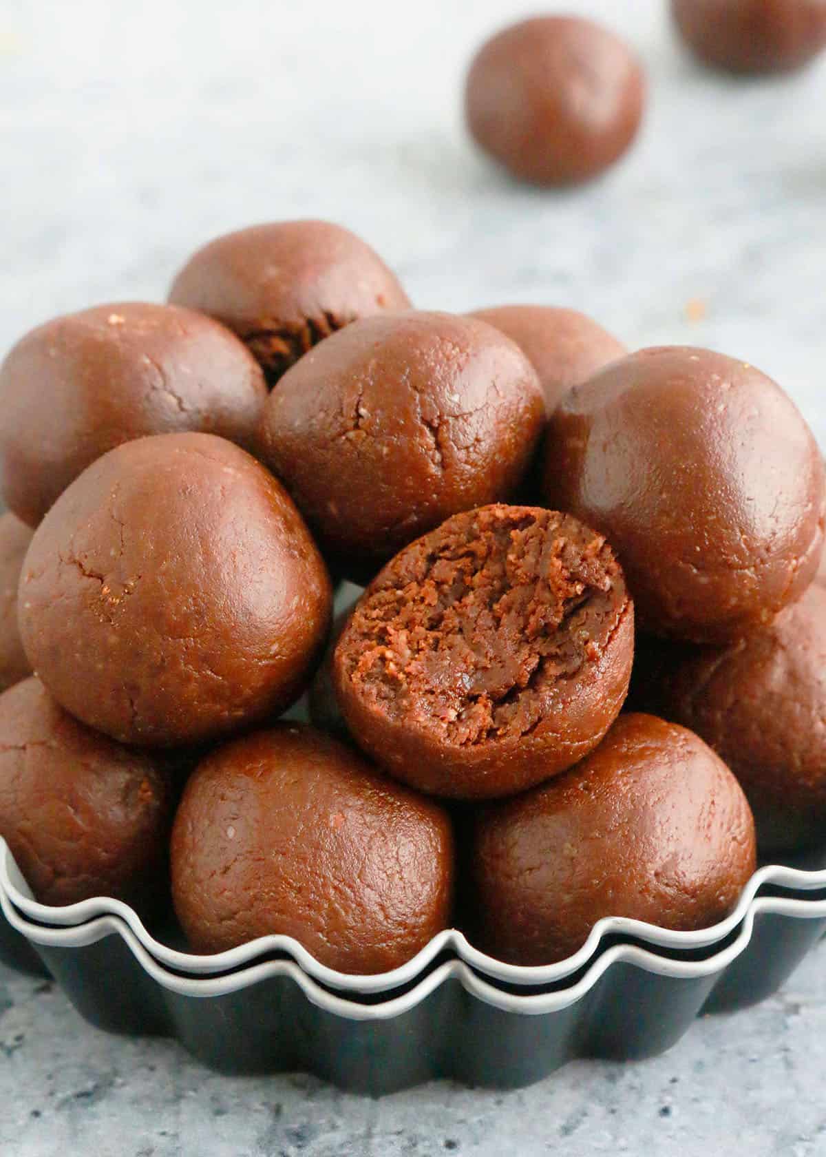 brown chocolate balls piled high on a fluted metal plate.