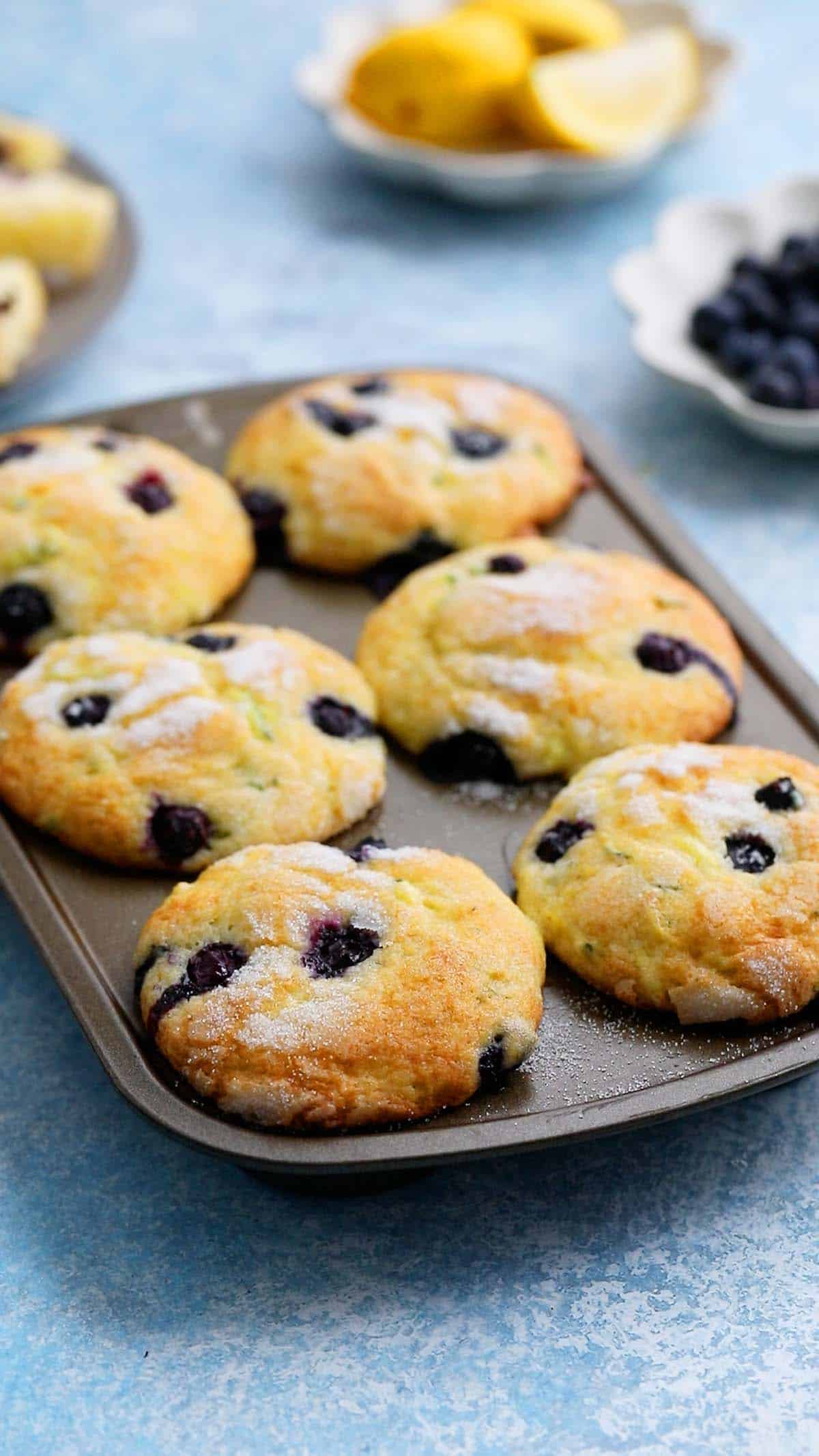 6 cup muffin pan with baked blueberry muffins.
