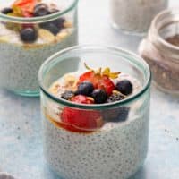 coconut chia pudding in glass jars with a spoon.