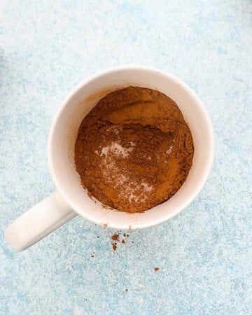 brown flour mixture in a white mug.