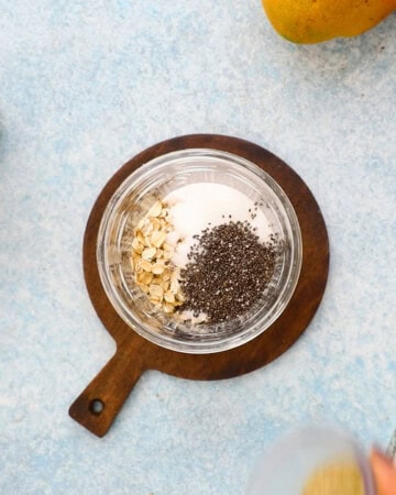 one glass jar with oats, sugar and black chia seeds.