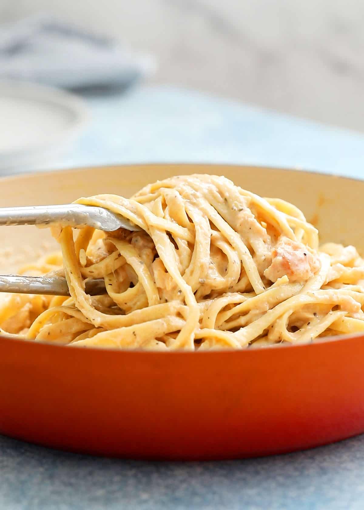 cooked fettuccini in a large orange skillet.