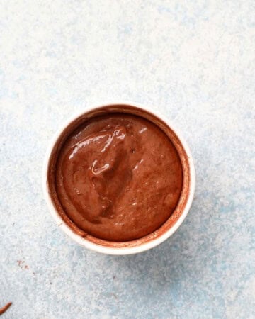 one white small ramekin with chocolate lava cake batter.