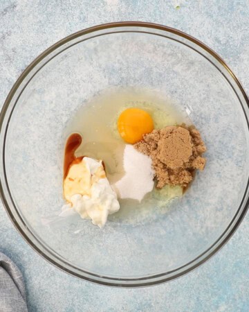 egg, brown sugar, and white yogurt in a large glass bowl.