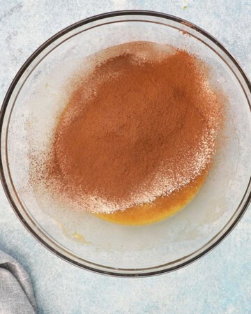 chocolate zucchini muffin batter placed in a glass bowl.