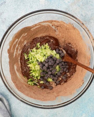 chocolate zucchini muffin batter placed in a glass bowl.