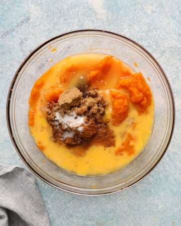 all ingredients needed to make butternut squash casserole in a glass bowl.