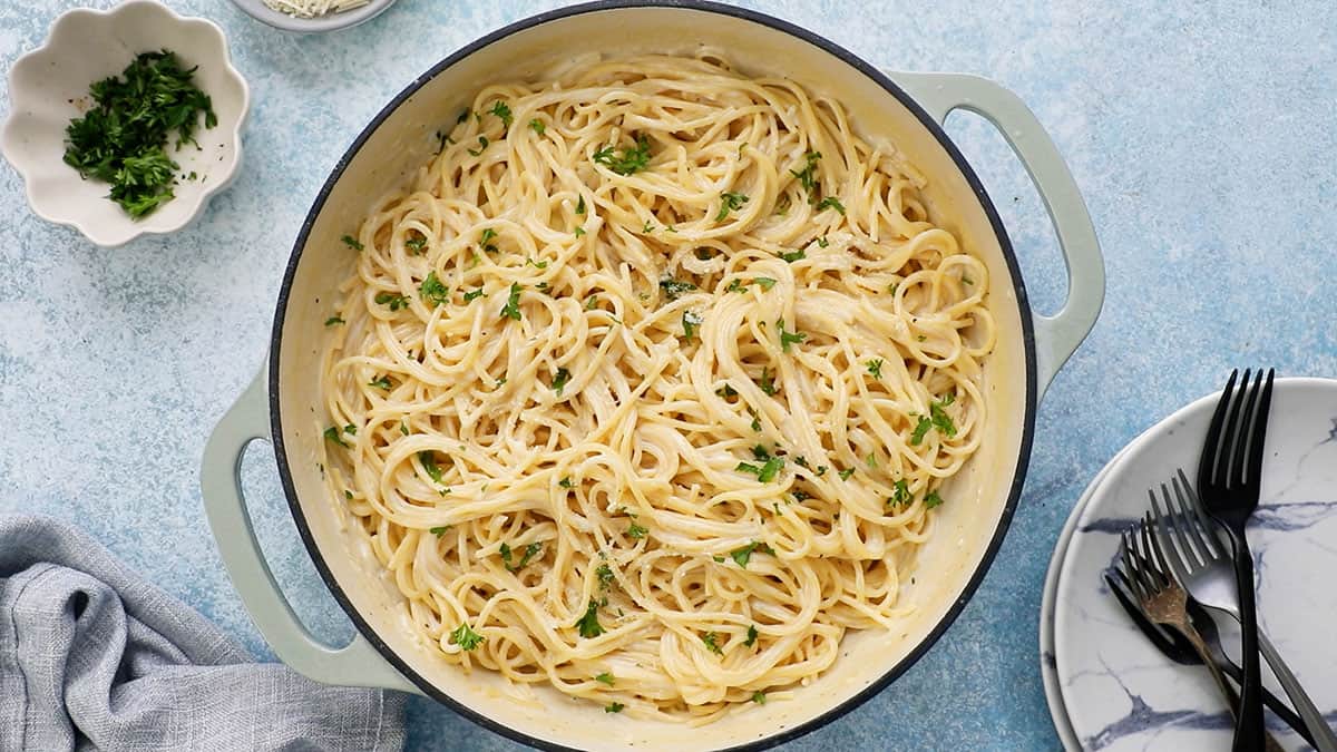 cooked white spaghetti noodles in a large white pan. 