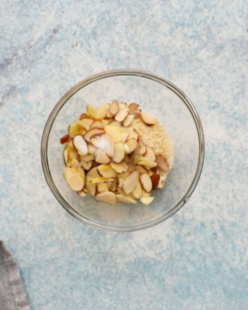 sliced almonds and breadcrumbs in a small glass bowl.