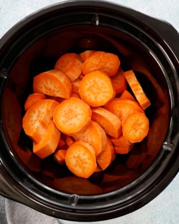 sliced sweet potatoes placed in a black pot.