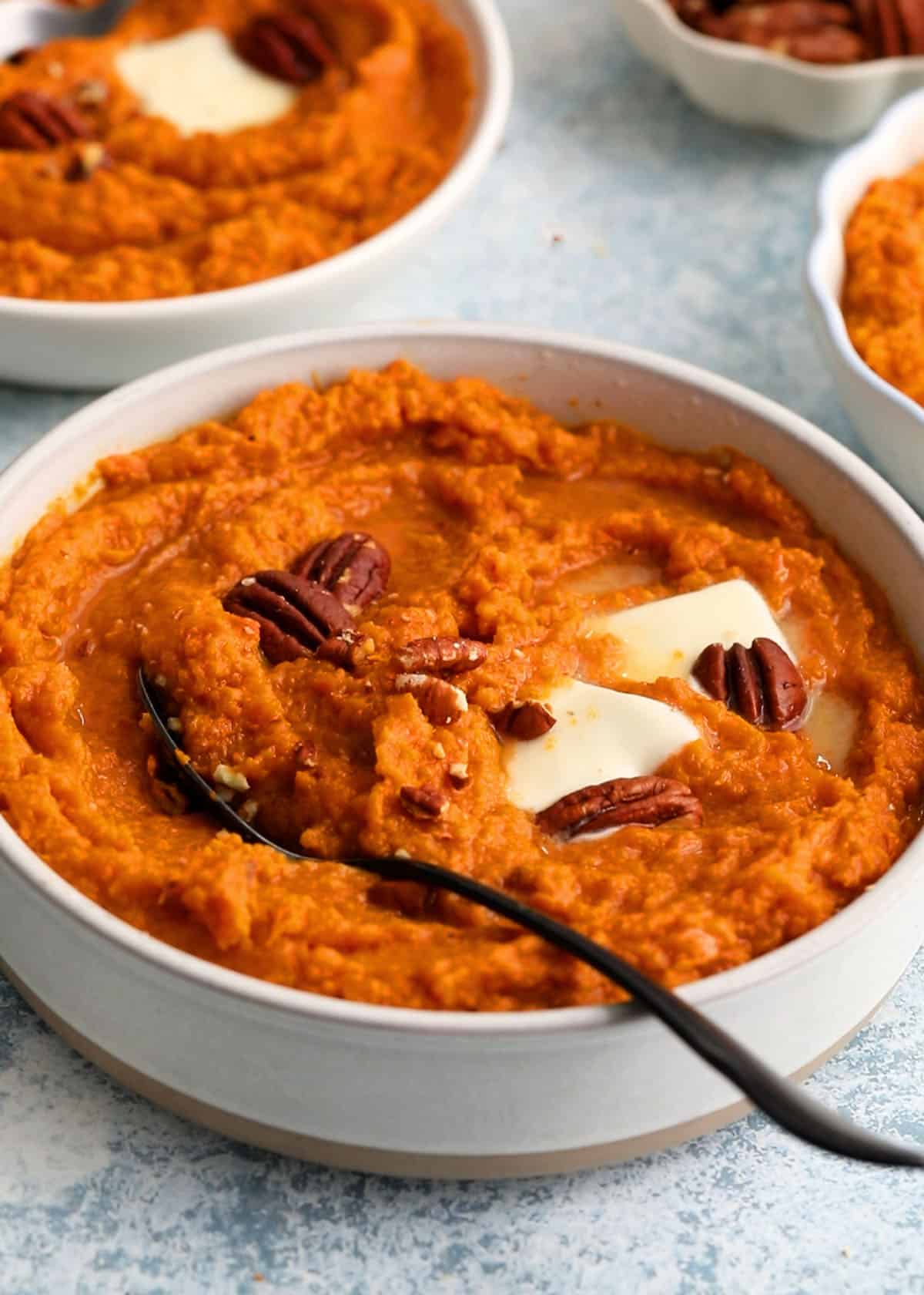 mashed sweet potatoes in a white bowl.